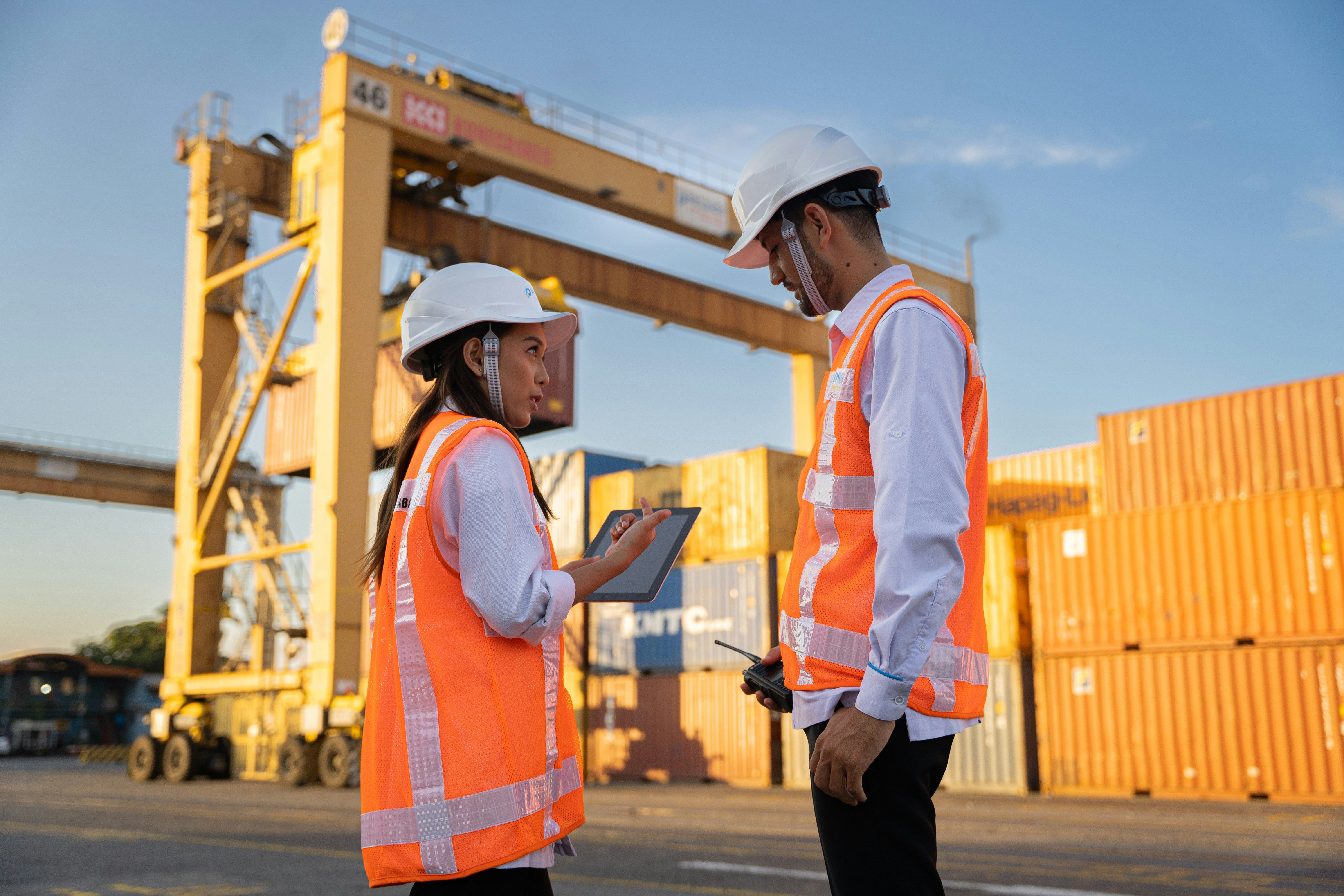 Two Antagon-placed supervisors in hi-vis reviewing work at an industrial site